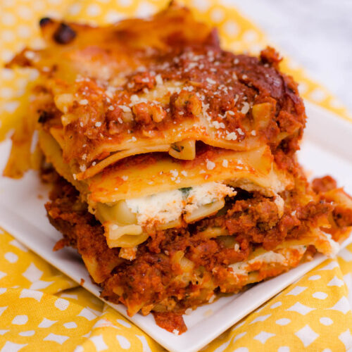 Piece of lasagna on white plate