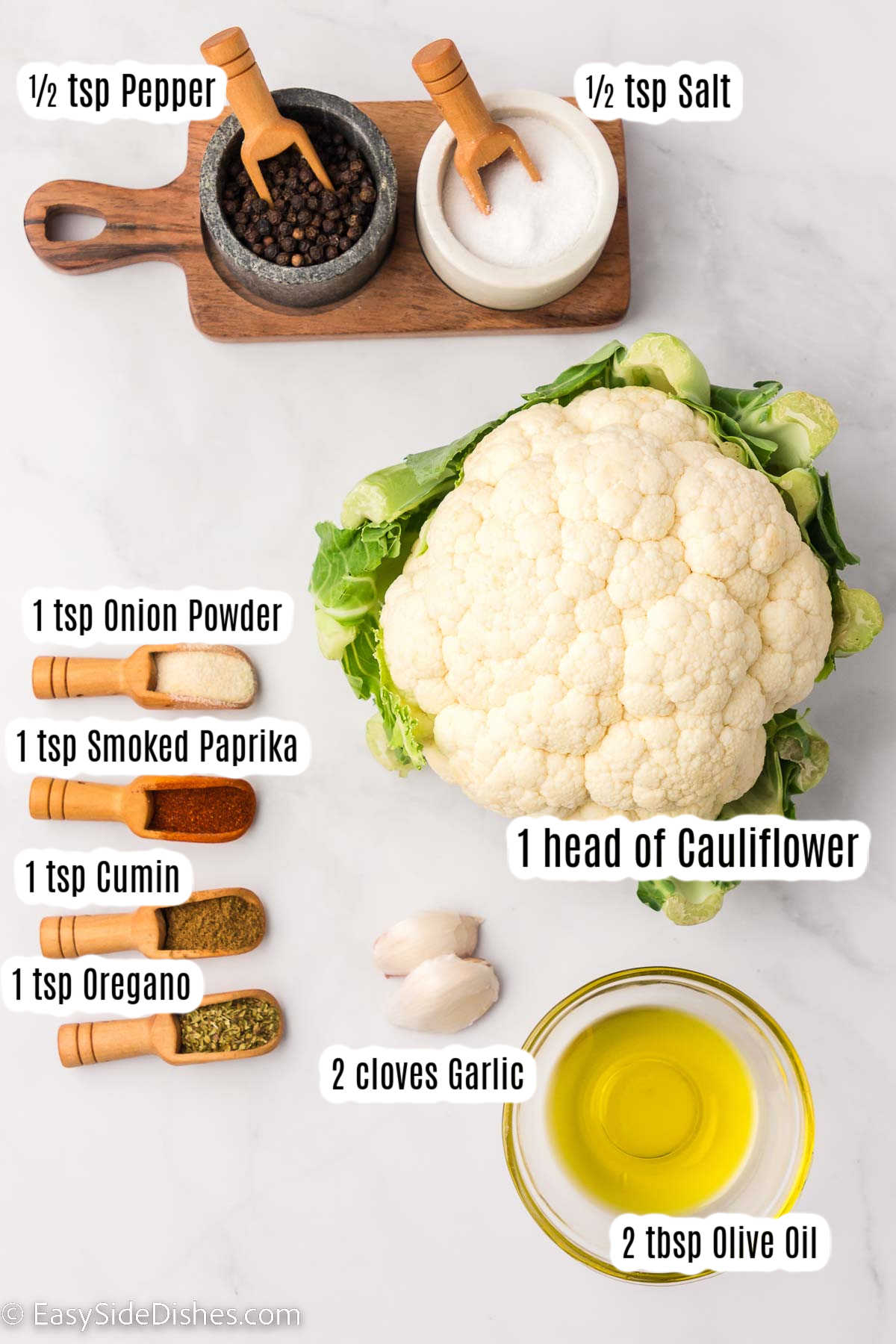 Ingredients on table, that are labeled for seasoned baked cauliflower. 